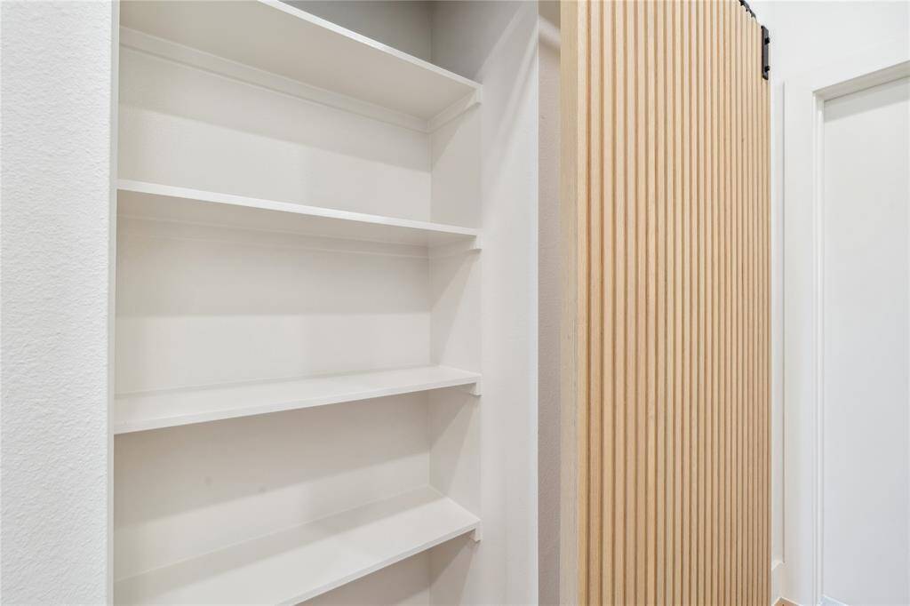Designed for efficiency, this utility room offers smart storage solutions in a sleek layout.
