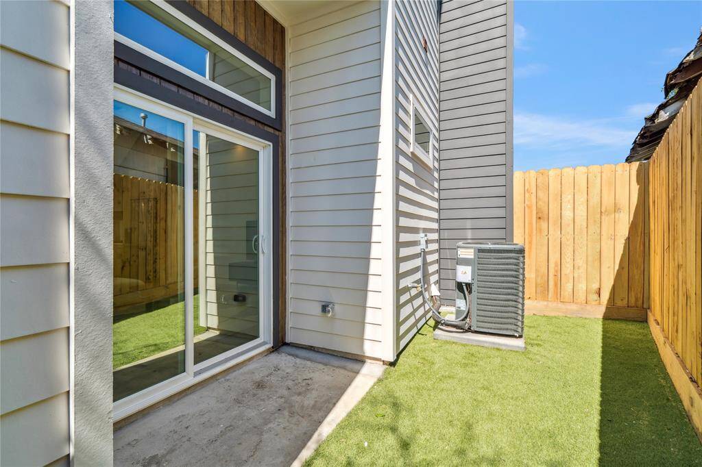 A stylish covered porch opens to a compact, functional green space for versatile outdoor living.