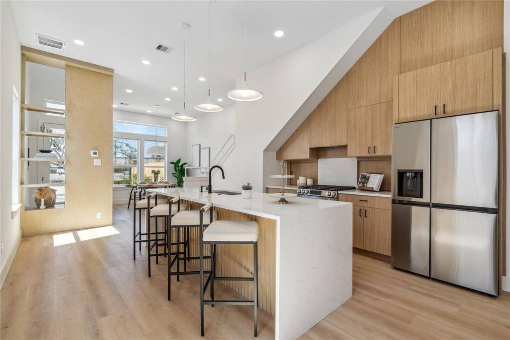 This distinctive open-concept layout strikes the perfect balance, providing subtle separation while using carefully chosen finishes to create a cohesive and flowing space.