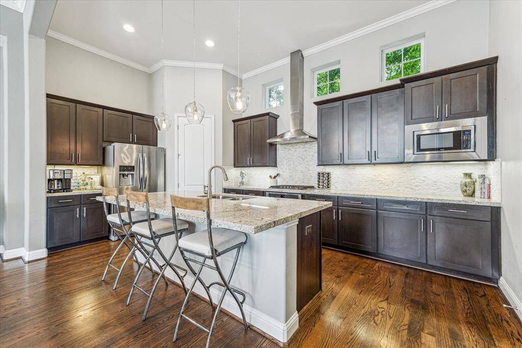 This stylish island kitchen features Energy Star stainless steel appliances, granite countertops, tile backsplash, under-cabinet lights, ample cabinetry plus a walk-in pantry for all your storage needs. Bar seating at the island offers the perfect spot for casual meals or chatting with guests while you cook.