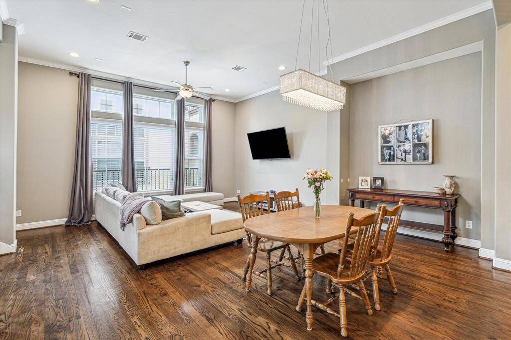 With rich wood flooring, neutral paint, and chic lighting, this dining area is the kind of space where everyone naturally wants to gather. Let the good times roll, whether it’s a casual Sunday brunch or a lavish dinner party.