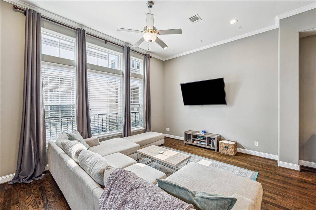 Unwind in the cozy family room, where soft neutral paint, crown molding, stunning hardwood flooring, and recessed lighting come together to offer both comfort and style.