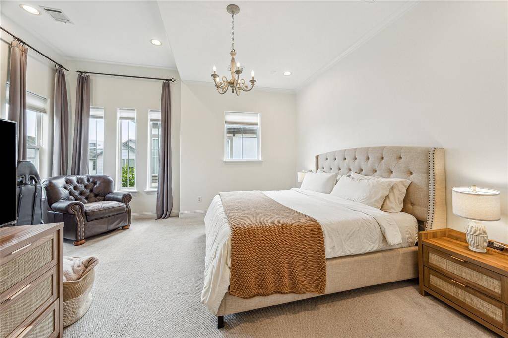 You'll have sweet dreams in this third-floor owner's retreat with plush carpet, neutral paint, a raised ceiling with an elegant chandelier, oversized windows, a large walk-in closet and a luxurious ensuite bathroom.