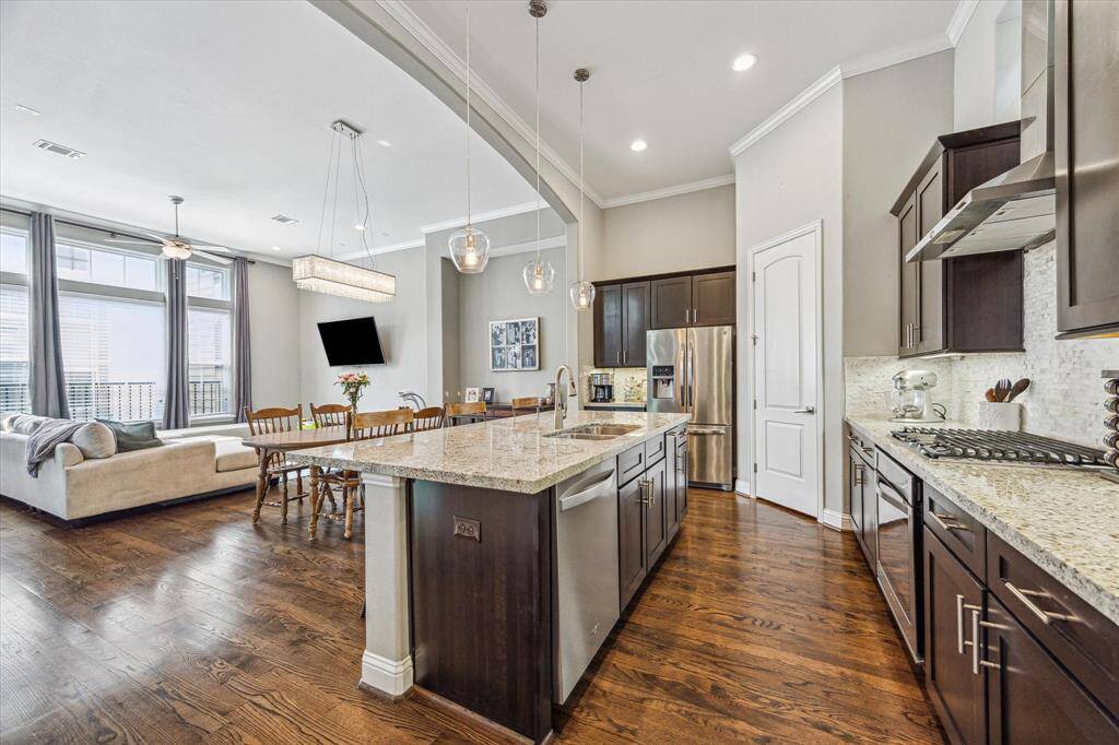 Ditch the takeout and enjoy home-cooked meals more often in this chef-inspired island kitchen! You'll find Energy Star appliances, granite countertops, a walk-in pantry, and plenty of cabinetry to keep everything organized. Under-cabinet lighting and stylish pendants add a designer touch, while bar seating at the island creates the perfect spot to sip, snack, or socialize.
