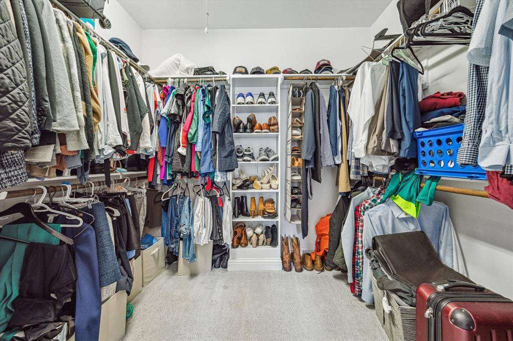 Shop until you drop! This massive walk-in closet offers plenty of space for hanging clothes, shoes, bags, and more.