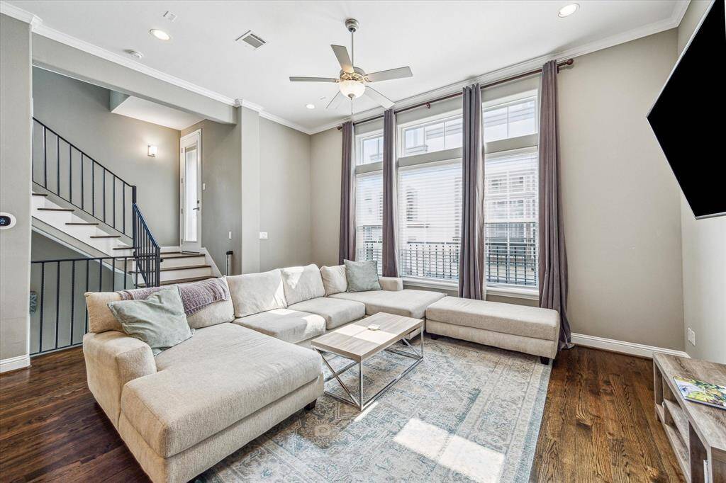 Natural light fills the main floor thanks to a wall of tall windows, creating a bright, welcoming space that feels open and airy all day long.