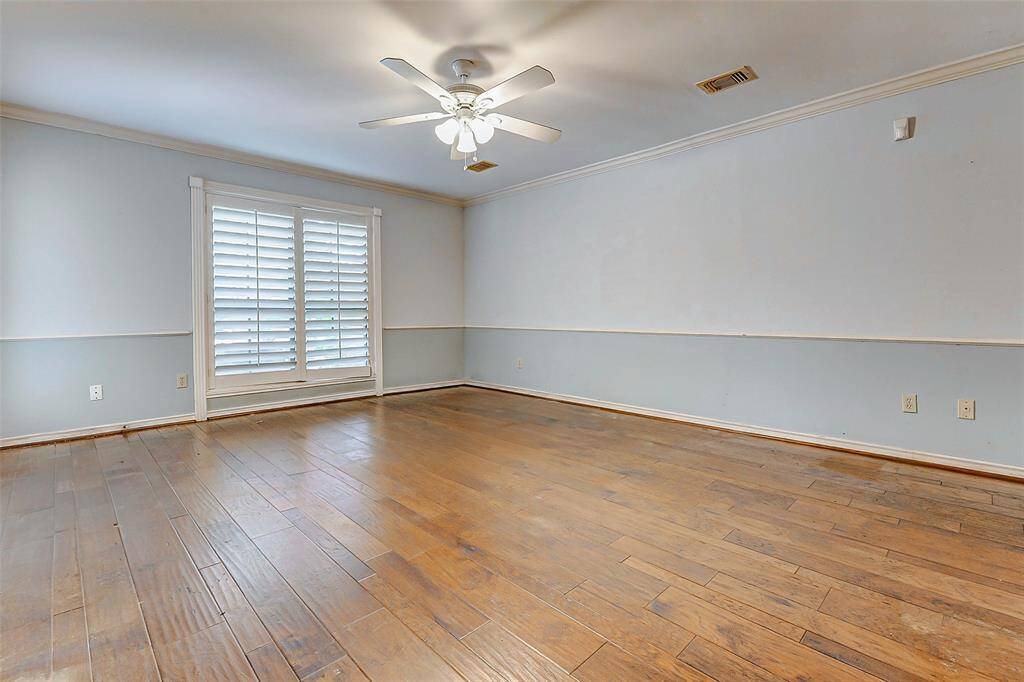 Large primary bedroom with hardwood floors