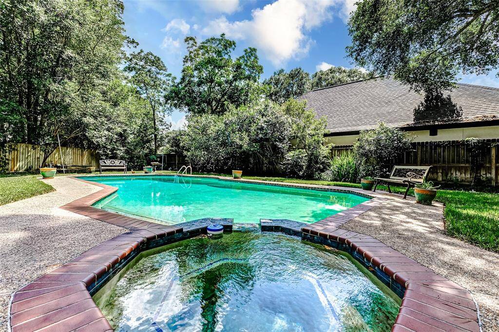 sparkling pool with an attached hot tub.