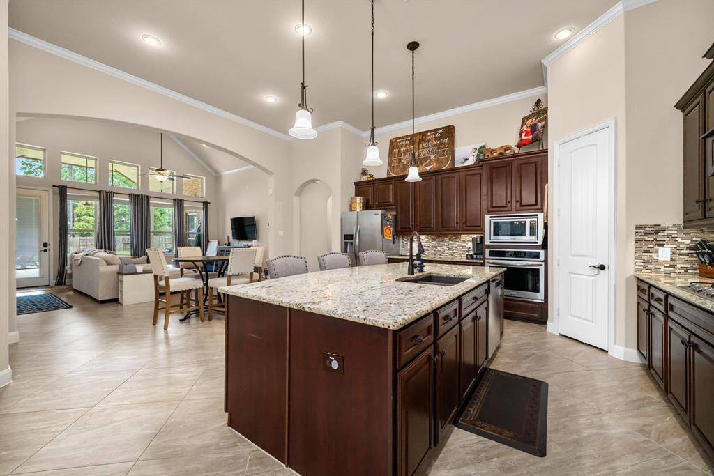 The open floor plan of this home lends to gathering and entertaining. Plenty of room to cook, serve and visit.