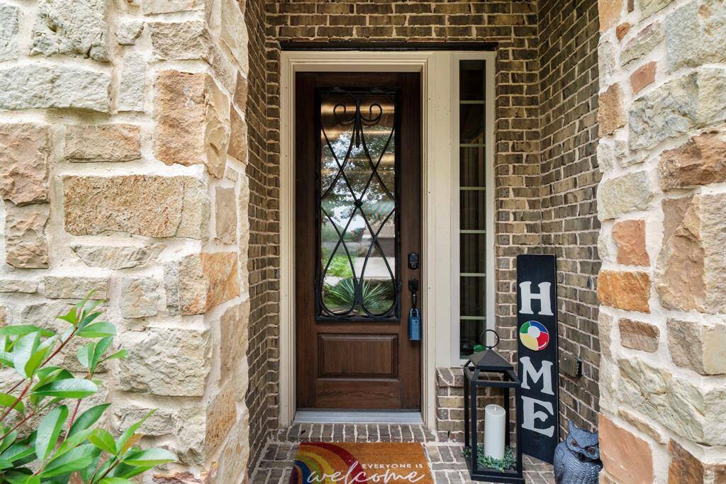 Beautiful stone facade and entry greet your guests for your next family occasion or pool party.