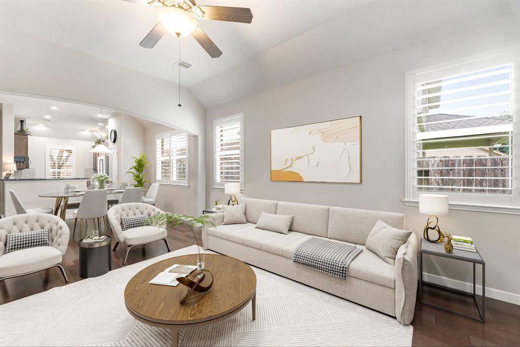 Gather the family and guests together in your lovely living room! Featuring high ceilings, recessed lighting, dark stained ceiling fan, custom paint, wood style floors, and large windows that provide plenty of natural lighting throughout the day. *Virtually Staged
