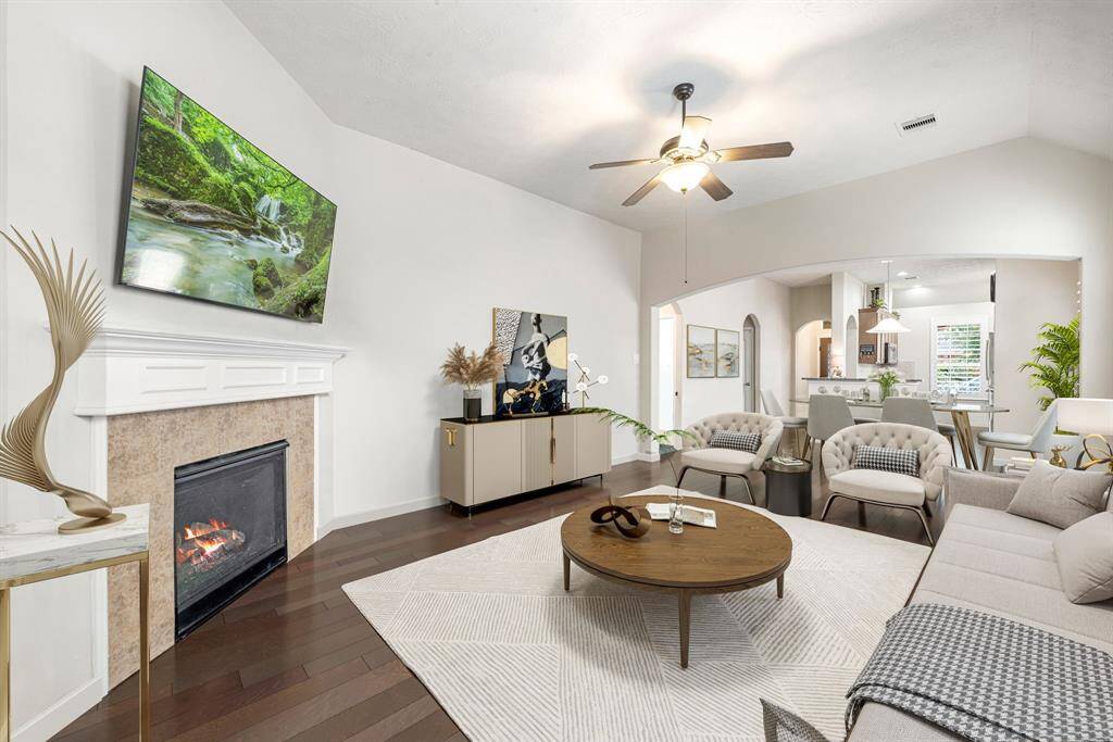 This light and bright spacious living room is the perfect layout for entertaining or just relaxing. Whether it's simply a night in or entertaining family and friends, this home has ample open space for everyone to enjoy! Featuring dark stained ceiling fan, large tile flooring, large windows with blinds, soaring high ceilings, recessed lighting with wonderful access to your gorgeous kitchen. *Virtually Staged