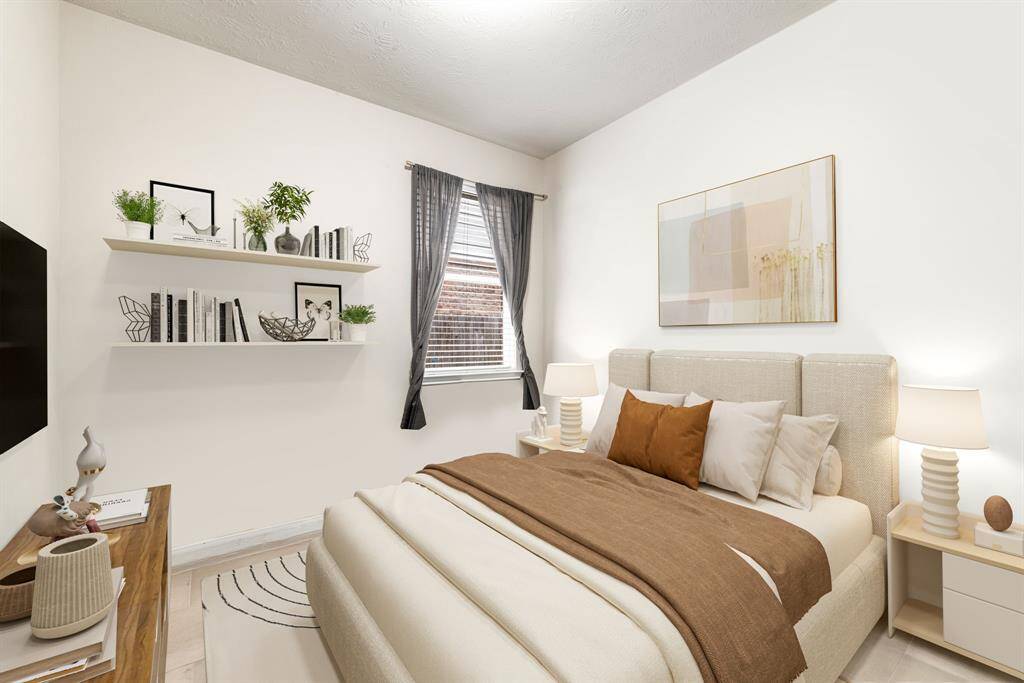 Secondary bedroom features plush carpet, custom paint, dark stained ceiliand a large window with privacy blinds. *Virtually Staged