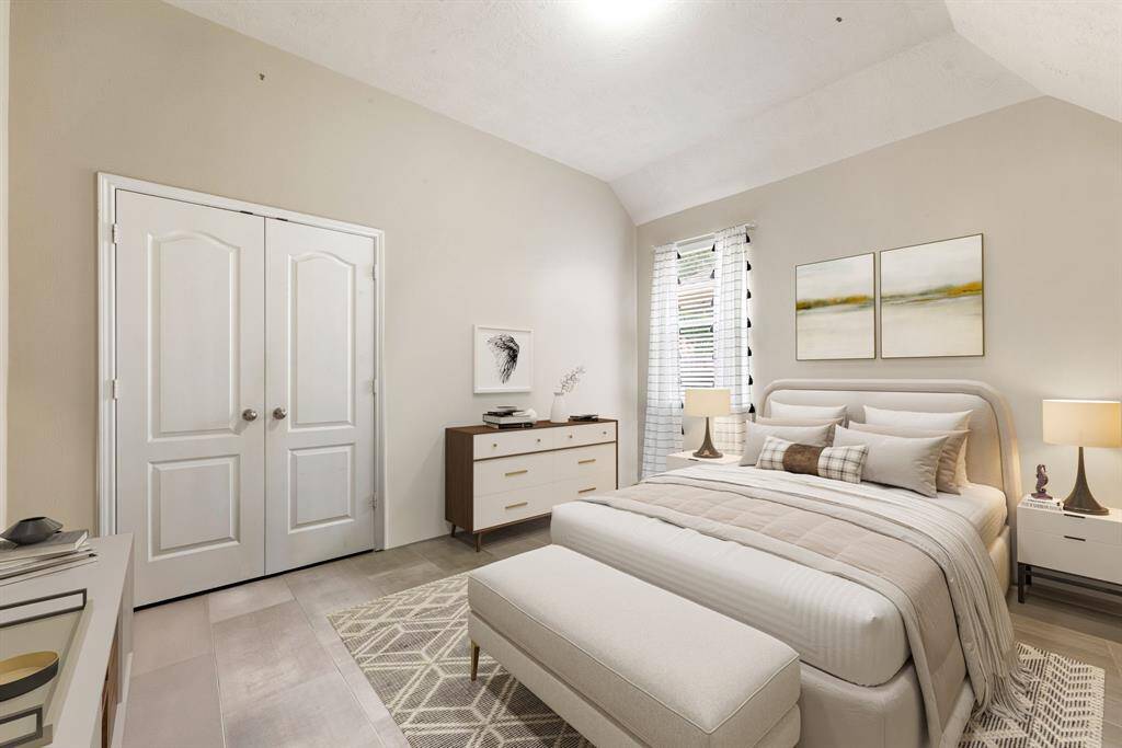 Secondary bedroom great for use as an in-law suite or guest suite features high ceilings, lovely modern ceiling fan, custom paint, plush carpet, space for seating area, direct access to the secondary bathroom and large window with privacy blinds. *Virtually staged