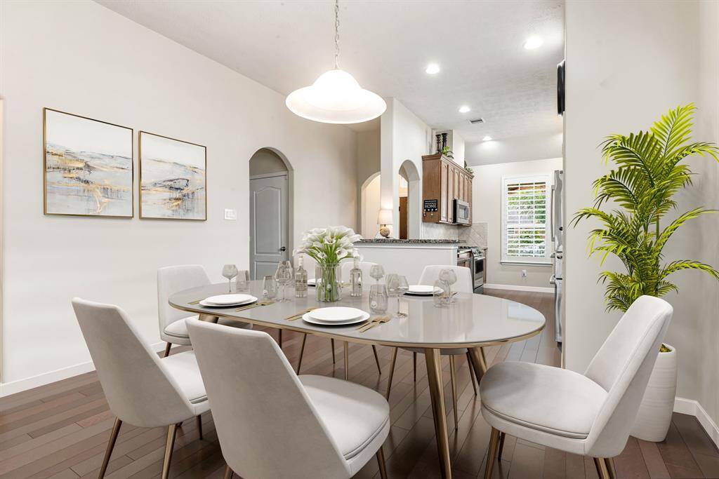 Host memorable meals in this open-concept dining area, which flows effortlessly between the kitchen and living room to create a cohesive, stylish gathering space. *Virtually Staged