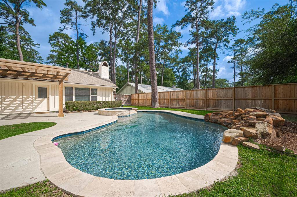 Stunning custom-built pool with hot tub and water feature.