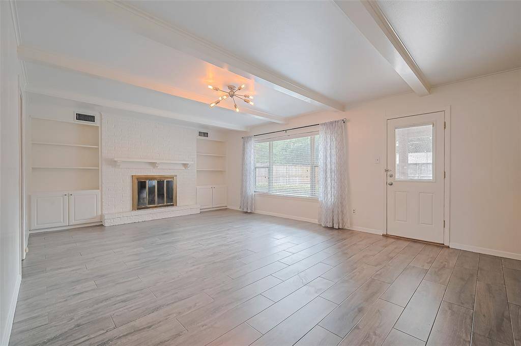 View of the family room with wood burning fireplace.