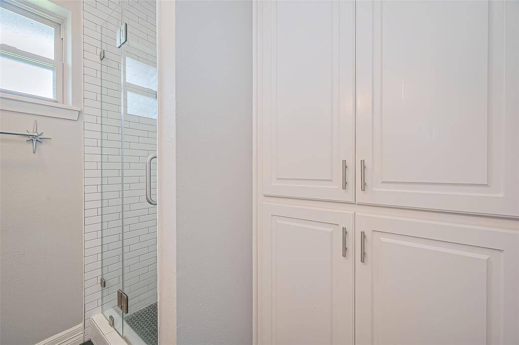 Primary bathroom has built in cabinets.
