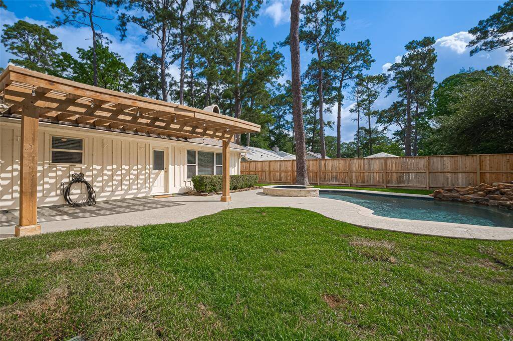 View of the back yard, pool and covered patio.