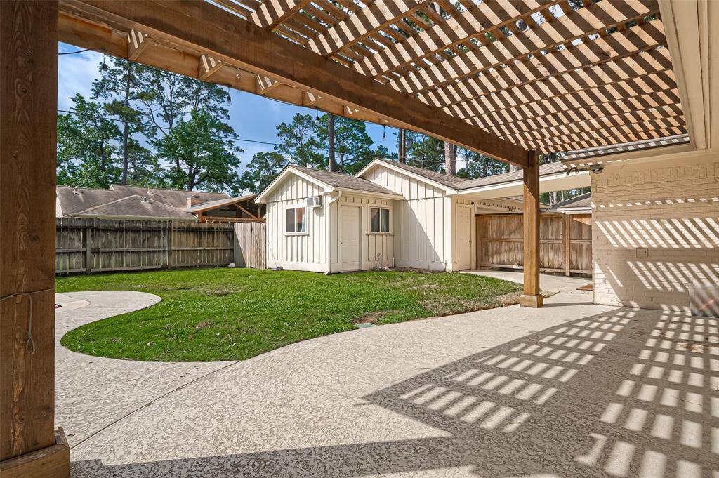 Additional view of the back patio looking over garage and additional storage room.
