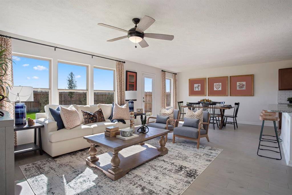 This GREAT room is the perfect room! Featuring high ceilings, ceiling fan, an amazing wall of windows providing a lovely view of your backyard, custom paint, and beautiful glazed porcelain tile flooring!