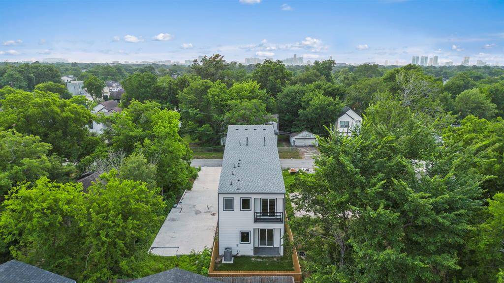 Rear aerial view highlighting fenced backyard