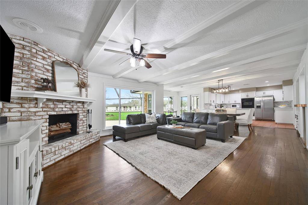 This open-concept farmhouse is fully completed, featuring stunning views of the property, with windows that beautifully invite the outdoors inside.