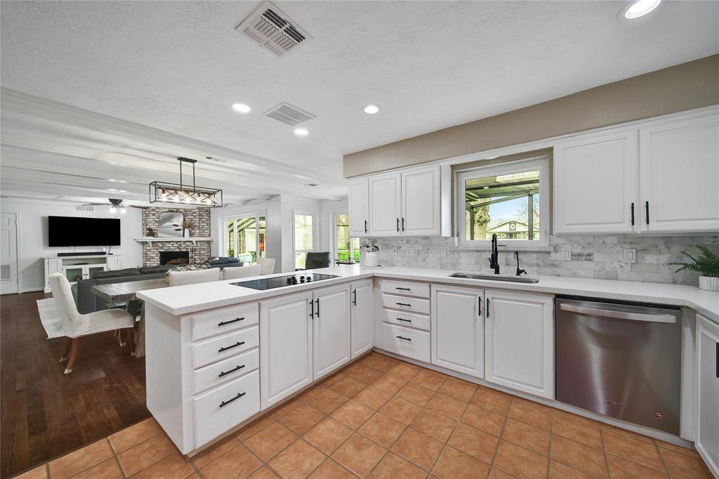 An open kitchen seamlessly connects to the living area, creating a bright, inviting space that enhances entertaining, fosters togetherness, and allows for easy interaction while cooking.