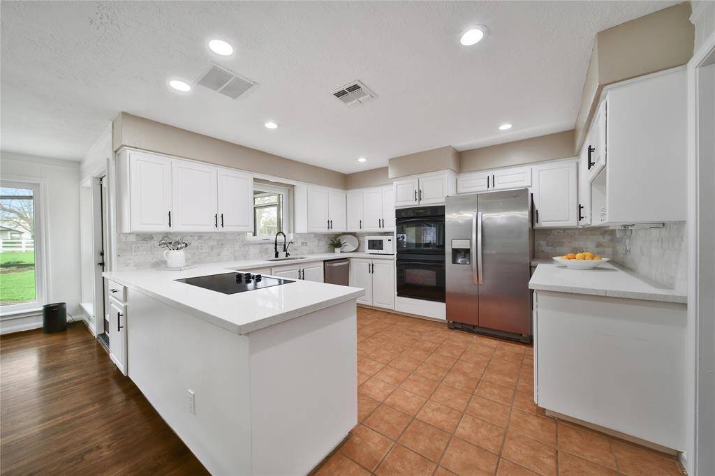 An open kitchen provides plenty of space for multiple cooks to move freely, making meal preparation more efficient and enjoyable. Kitchen Refiegerator can stay.