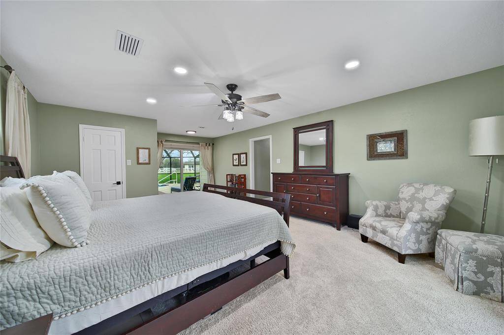 The primary bedroom features a separate sitting area with private access to the pool through sliding doors.