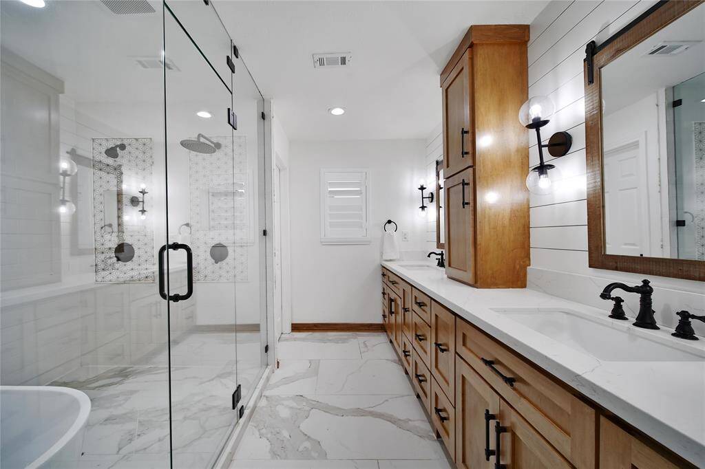 The primary bath was completely renovated (2022) into a stunning spa-like retreat, perfect for both to relax and get ready in style.