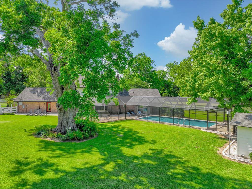 The gorgeous enclosed back porch is another perfect way to enjoy some quality outdoor time without having to succumb to the elements. The stucture was fully re-screened in early 2025. While it is without leaves now, this incredible 200 year old Pecan tree has been registered with the State of Texas! (wow!)
