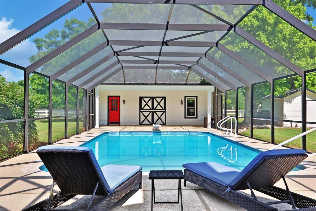 The custom built enclosure stands tall over the pool itself, keeping the sunlight in and the bugs out - the ideal situation for any hot Texas summer day. The pool was resurfaced in 2022 while the coping , diving board (not shown) and hand rails were all redone in 2025.