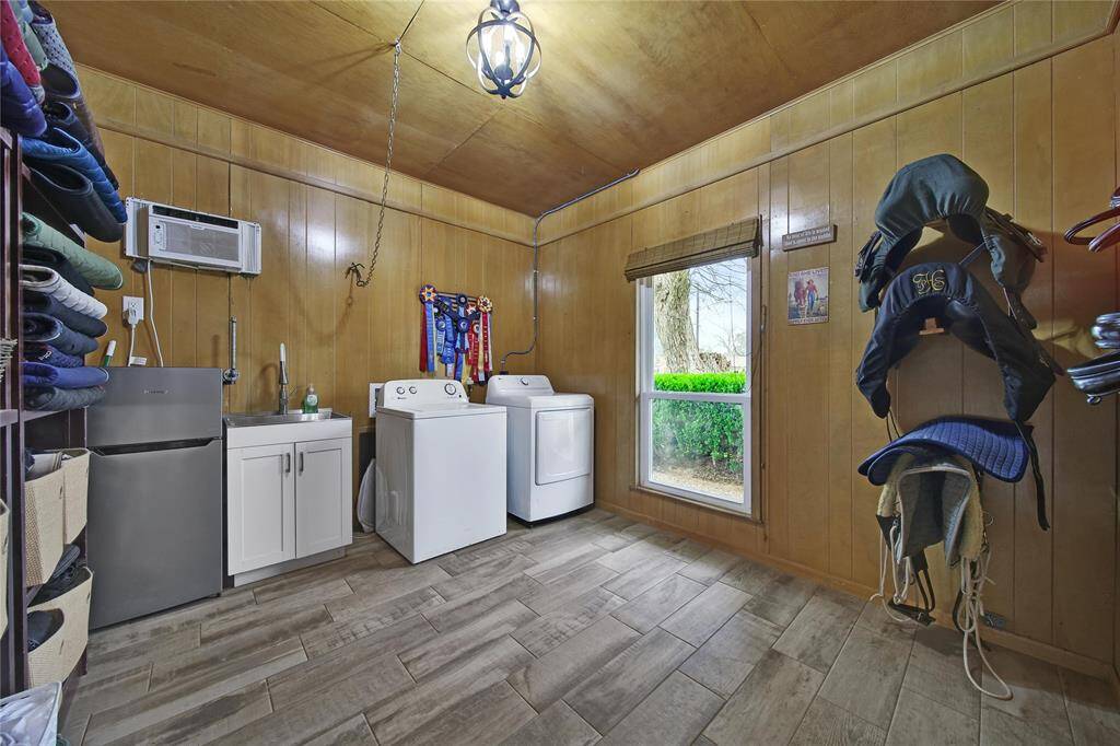 The climate controlled tack room includes room for multiple saddles, all needed tack, washer/dryer (included), utility sink, and fridge, with room to spare.