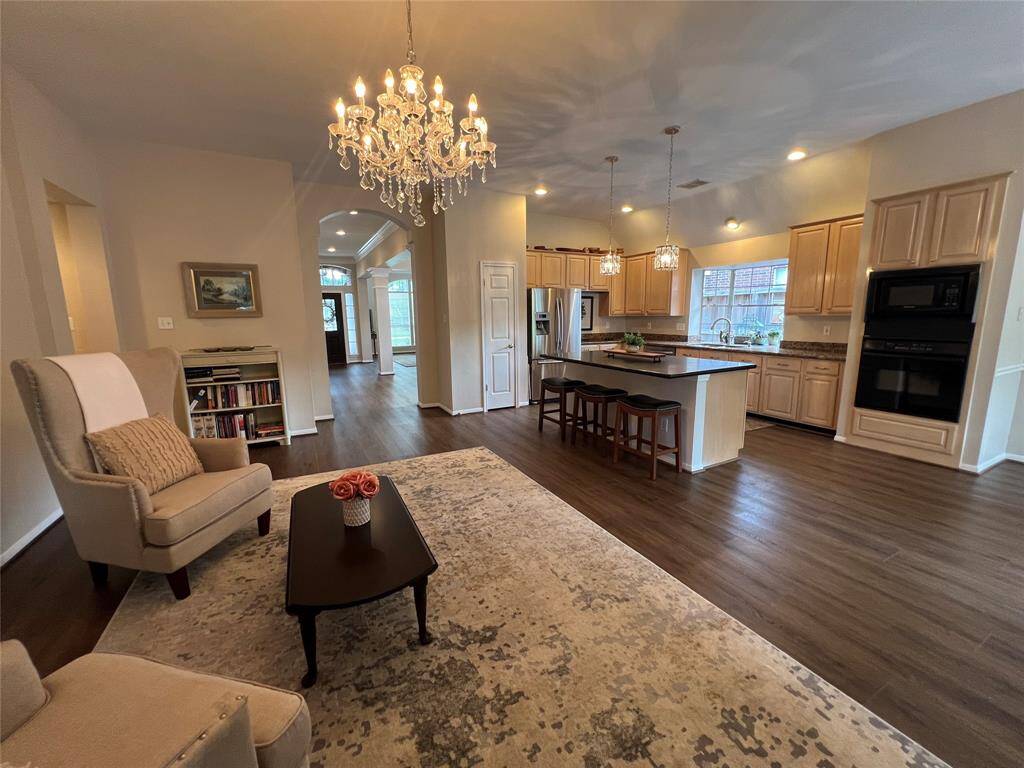 Lovely family room with charming chandelier and cozy fireplace.