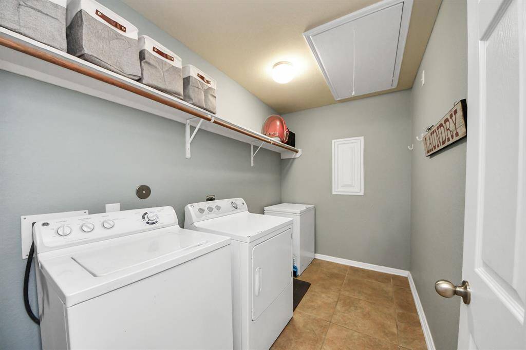 Laundry room tucked away with extra space for storage.