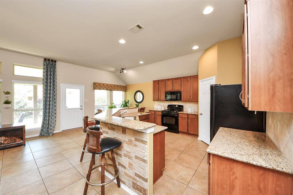 Open-concept kitchen with generous counter space and a functional breakfast bar.