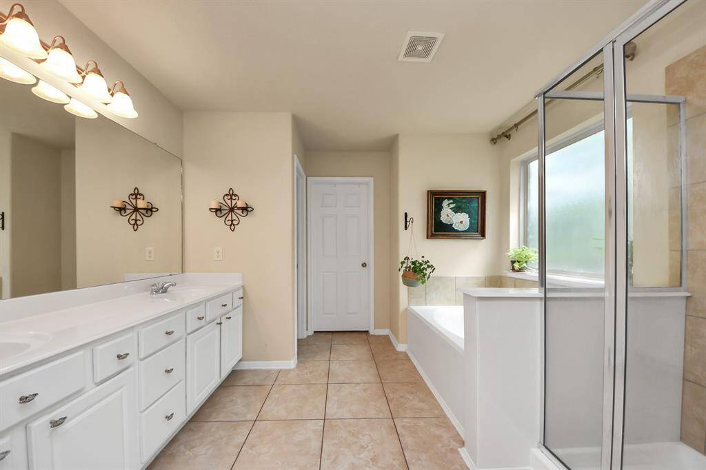 Ensuite features dual sinks, tub and shower.