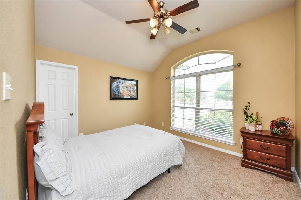 One of two front secondary bedrooms with easy bathroom access in hall.
