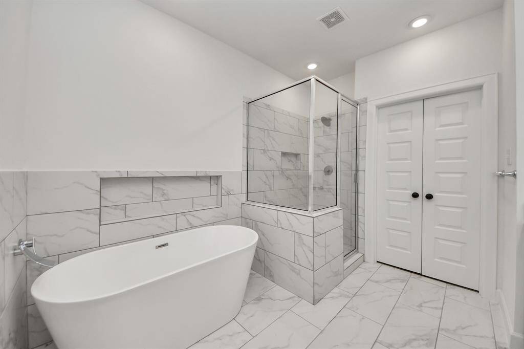 Enjoy the relaxing modern soaking tub in this bathroom oasis!