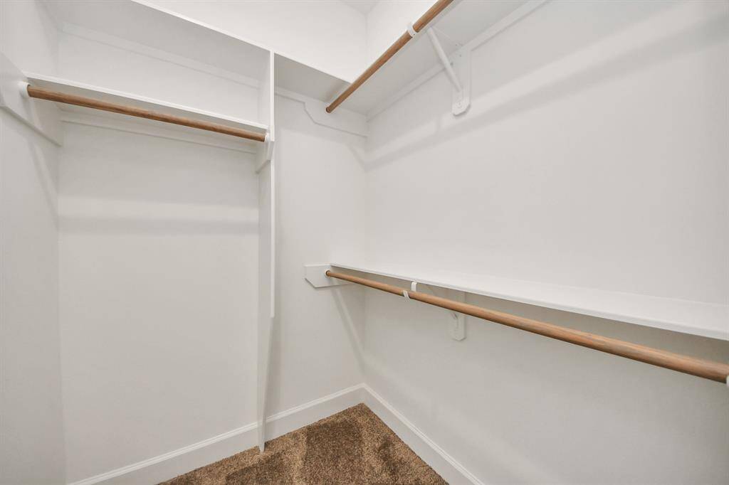The guest bedroom includes a spacious closet, offering plenty of storage