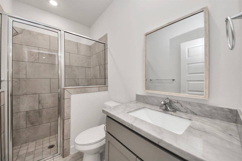 Guest bedroom includes its own en-suite bathroom for added comfort.