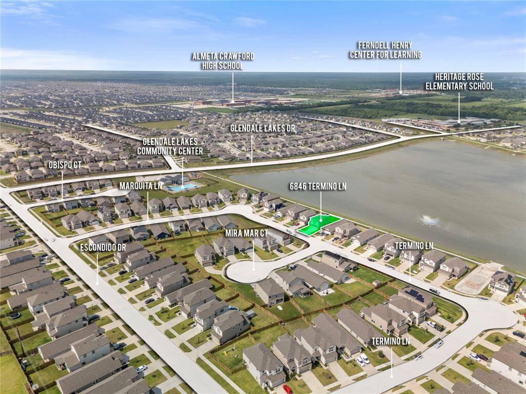 This aerial photo shows a suburban neighborhood with a highlighted lot at 6846 Termino Ln, adjacent to a scenic lake. Nearby are schools, a community center, and well-maintained streets lined with modern homes, offering a family-friendly environment.
