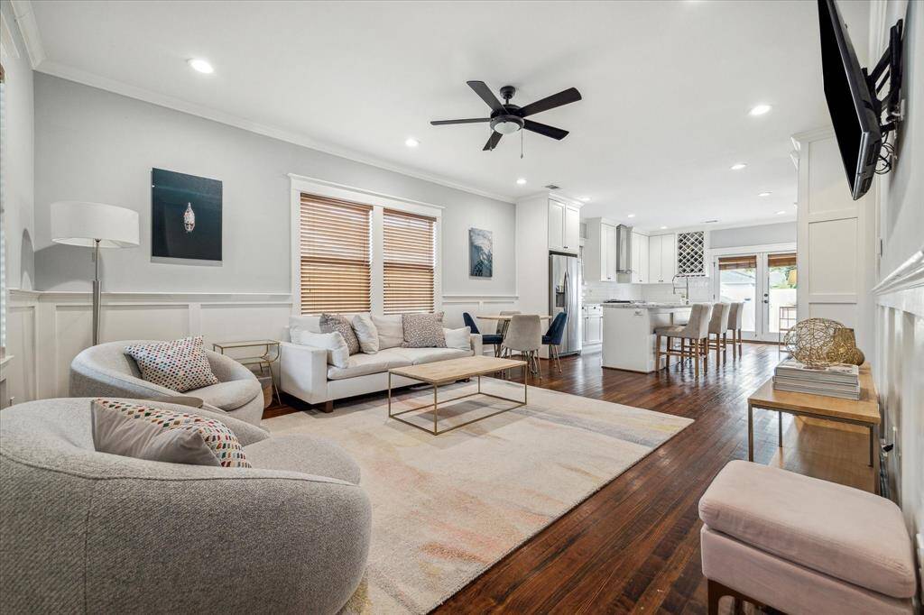 Upon entry, the spacious open concept living area offers beautiful millwork, hardwood floors, and crown molding.