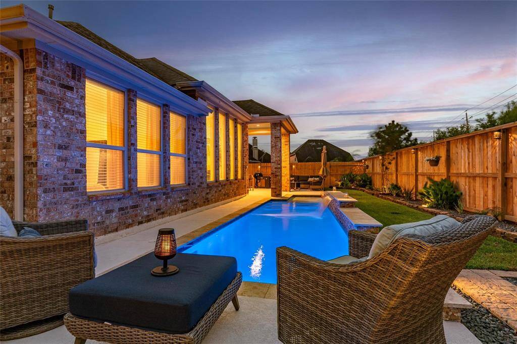 This modern kitchen features slide-out pots & pans drawers in most cabinets for convenience of space. Gorgeous large island with granite countertops, and modern stainless steel appliances. It opens to a bright breakfast area with large windows, offering abundant natural light and a view of the backyard.