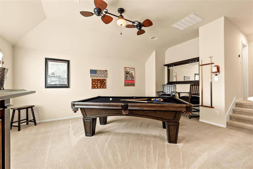 Upscale double ceiling fan, clean carpet, neutral paint tones and entertainment niche in the upstairs bedroom/gameroom.