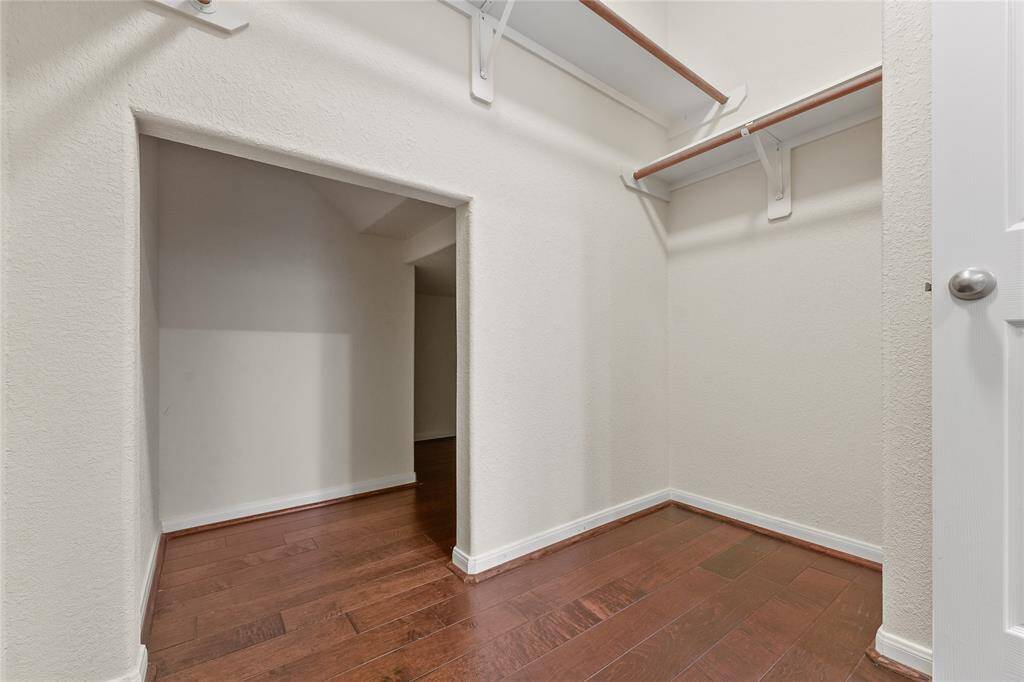 Primary bedroom walk in closet with extra nook and crannies for storage space!