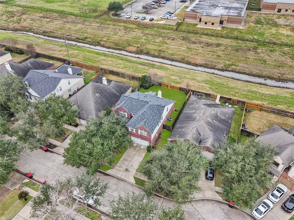 The property backs to a small bayou and the elementary school.