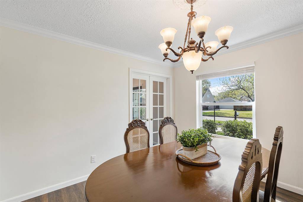 Elegant glass double doors provide privacy, perfect for a home office.