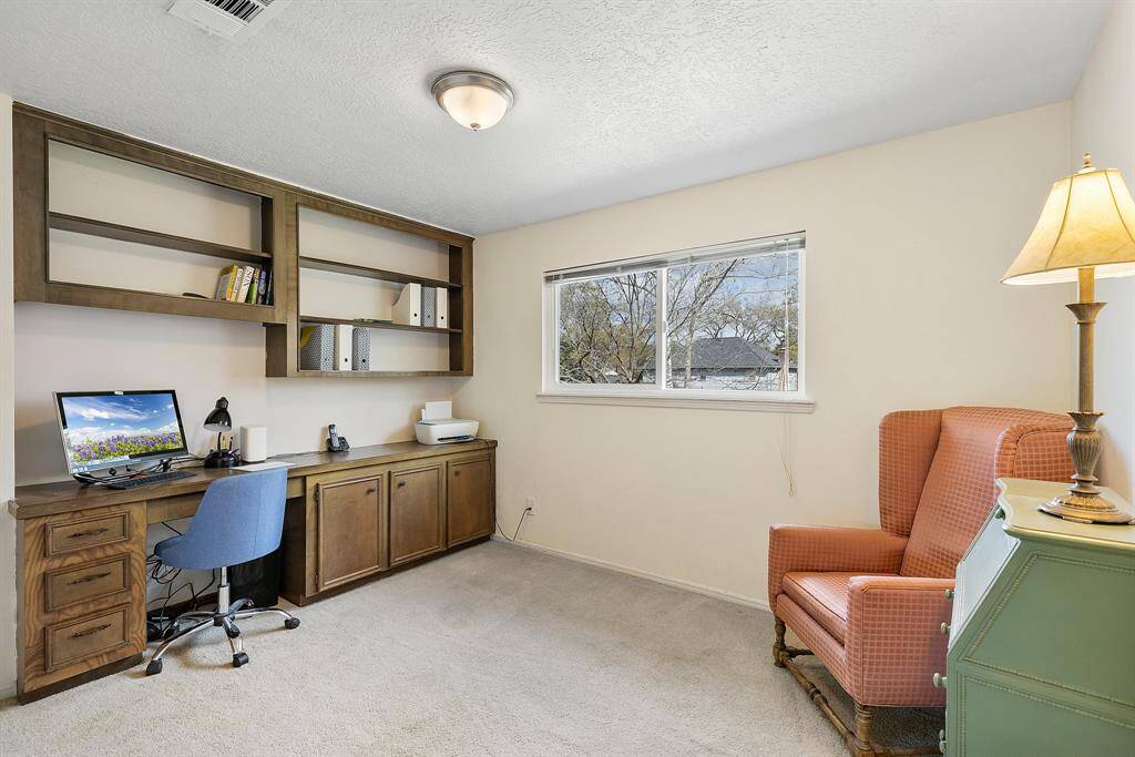 Charming third bedroom with built-in shelving, ideal for a cozy library or reading nook.